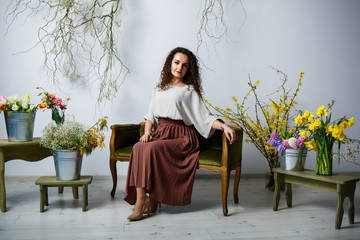 beautiful girl model with curls in a dress posing in beautiful arrangements. The beginning of...