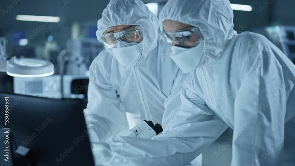 Poster research factory cleanroom: engineer and scientist wearing coveralls talk and work on computer, use 
