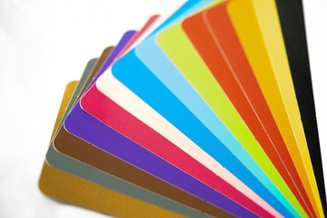 Close-up of color palette guide of stickers for decoration on white background.