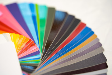 Close-up of color palette guide of stickers for decoration on white background.