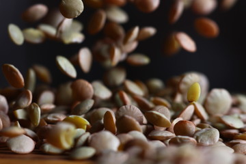 falling lentil grains in motion on a dark background