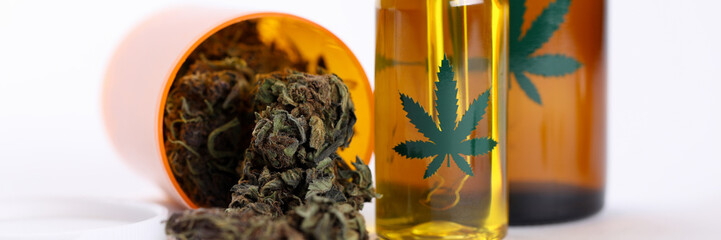 Close-up view of different plastic bottles with cannabinoid oils. Cannabis extract for cosmetology. Herb products of folk medicine. Health and treatment concept