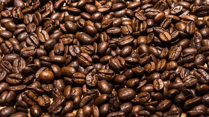 Dark roasted coffee beans for background, wallpaper, and design concept for food and drink themed photography.