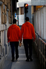 Two young men dressed in orange jacket