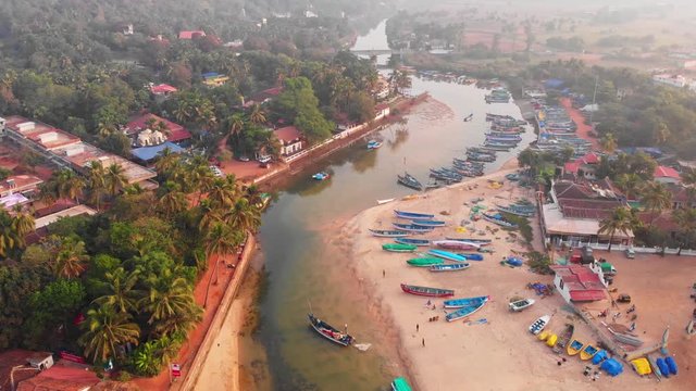 Aerial view of a small Indian river with wooden fishing boats on Baga Beach