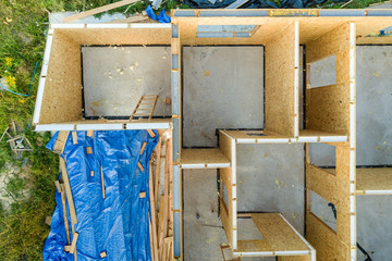 Construction of new and modern modular house. Walls made from composite wooden sip panels with styrofoam insulation inside. Building new frame of energy efficient home concept.