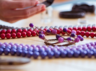 Woman making jewelry at home