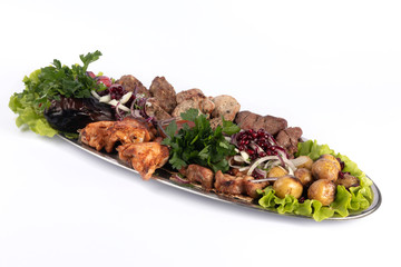 Barbecue assortment with fresh and fried vegetables on a white plate for menu and web