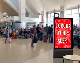 Crowd of people at airport terminal with Corona Virus Sign