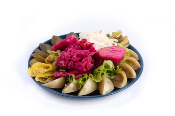 Appetizer of salted and pickled vegetables on a white plate for mana and web