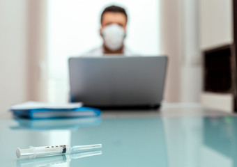 Close-up of the doctor background syringe with mask.