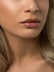 Obraz premium Closeup plump Lips. Lip Care, Augmentation, Fillers. Macro photo with Face detail. Natural shape with perfect contour. Close-up perfect natural lip makeup beautiful female mouth. Plump sexy full lips