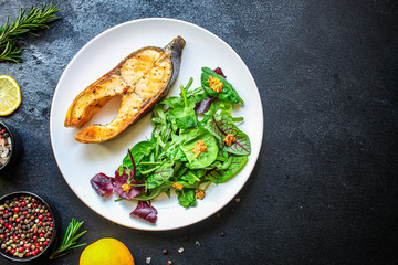 pink salmon steak fried and salad, grilled seafood, pescatarian Menu concept food background keto or paleo diet. top view. copy space for text
