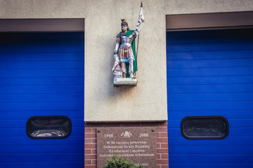Small statue of St Florian on the wall of fire department building in Laski village, Masovia region of Poland