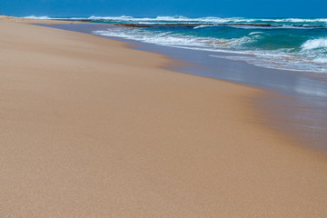 Fototapeta na wymiar Looking down shoreline of a sandy, Australian surf beach