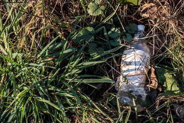 Plastic waste thrown away in the middle of nature