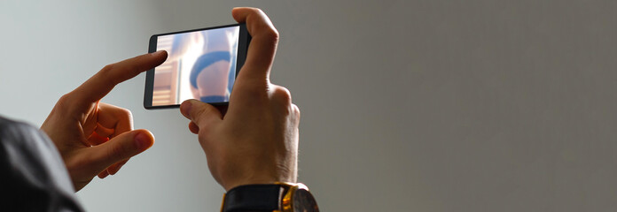 a young caucasian man lying on the couch watches porn in his tablet computer