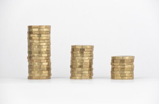 Descending stacks of new &pound;1 pound coins graph on a white background. 