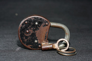 Old padlock with rust but fully functional photographed in the studio