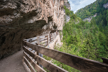 Fototapeta na wymiar panoramic route to Sanctuary of San Romedio trentino, Trentino alto adige, northern italy - Europe. Panoramic trail carved into the rock of the canyon