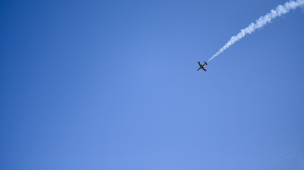 the plane against the blue sky flies from the upper right corner