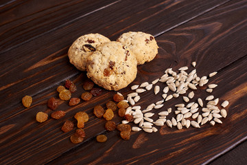 cookies with raisins and seeds on a brown background
