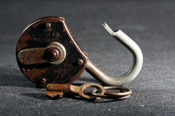 Old padlock with rust but fully functional photographed in the studio