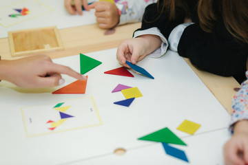 Close up of children play with different figures on the table