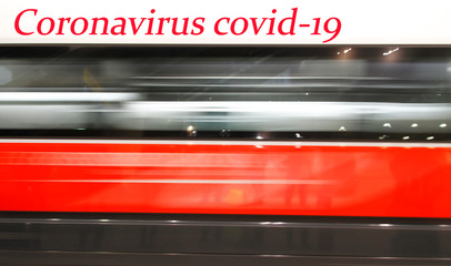 Stop coronavirus. Motion blur of high speed train in station.Train and passengers - red background. Travel Alert Concept. Health Risk. Pandemic concept