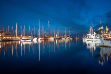 yachts in the marina, the view of the yachts and their reflection in the sea water, the dark blue...