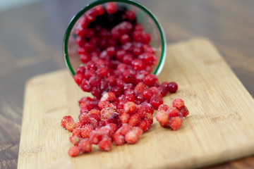frozen berries. raspberries, black and red currants. on a wooden table