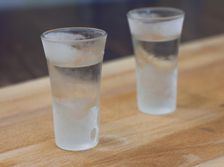 ice-cold vodka on a wooden counter. alcohol