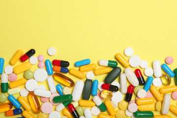 pills on a colored background top view. Medicine, treatment, illness. Medication in tablets.