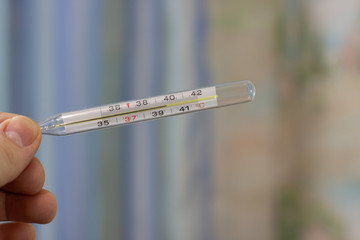 the thermometer shows a body temperature greater than 39 degrees