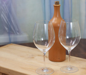 a bottle of homemade wine with two glasses on the table