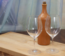 a bottle of homemade wine with two glasses on the table