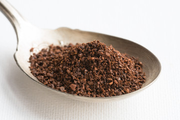 Ground Coffee Beans on a Vintage Spoon