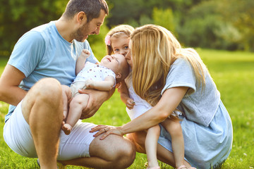 Happy family have fun playing in the park.