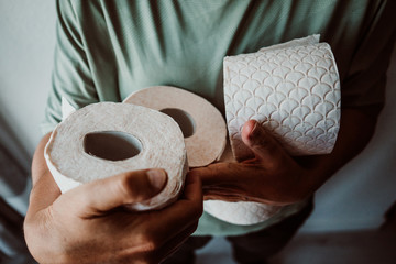 .Middle-aged woman hoarding a lot of toilet paper. Madness caused by the coronavirus health crisis.