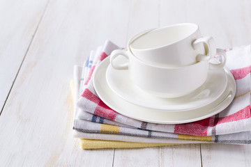 Cups on kitсhen towels stack