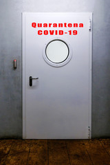 Armored door with the word Quarantine covid-19 in Italian.
