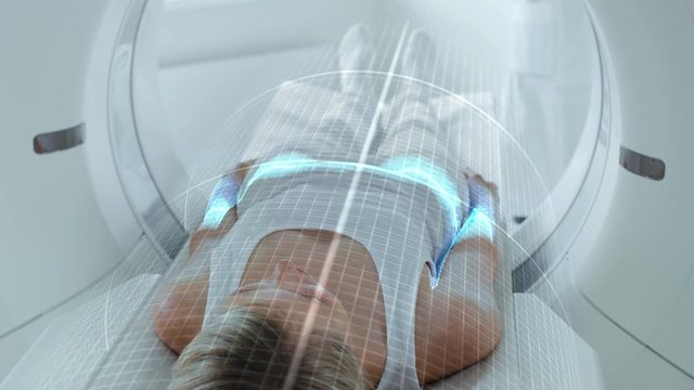 Female Patient Lying on CT or PET or MRI Scan Bed, Moving Inside the Machine While it Scans Her Brain and Body. Augmented Reality Concept with Visual Effects In Medical Lab with High-Tech Equipment.