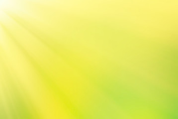 defocused yellow green blurred background with sunbeams
