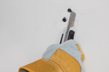 Plasterer home improvement handyman worker with putty knife working on apartment wall filling