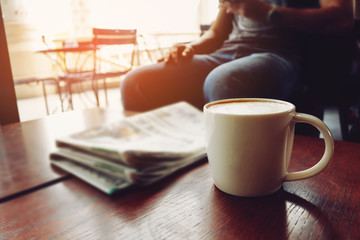 Latte coffee on coffee shop with heart pattern in a white cup on wooden table in cafe background
