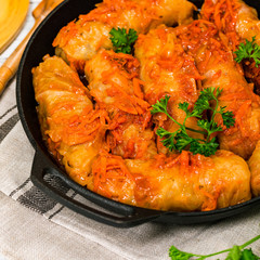 Stuffed Cabbage Rolls on Vintage Wooden Background. Selective focus.