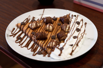 French Crepe Waffle Dessert Chocolate Melted Ice cream Banana Whipped Cream Served On Plate Restaurant Setting Table