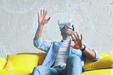 Naklejka premium Portrait of amazed excited man watching virtual reality glasses with open mouth expression