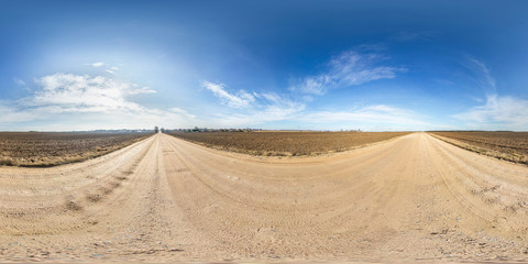 Fototapeta na wymiar full seamless spherical hdri panorama 360 degrees angle view on gravel road among fields in spring day with awesome clouds in equirectangular projection, ready for VR AR virtual reality content