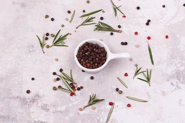 Black pepper inside a white dish.